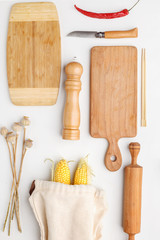 Composition of wooden cutting boards and wooden utensils and kitchen utensils. Top view.