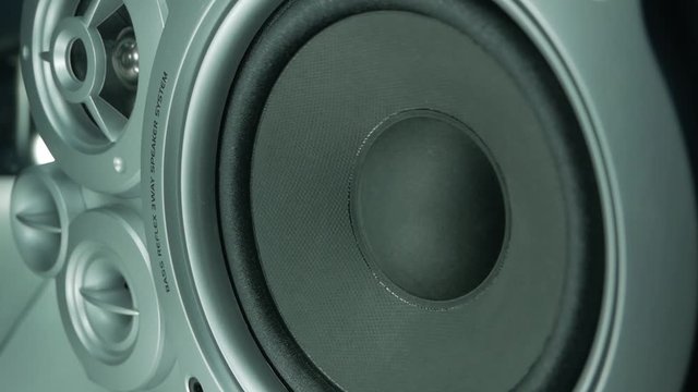 Close-up at moving sub-woofer. Speaker part music. Playing speaker membranes stacked in an endless loop.