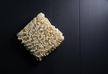 instant noodles on dark background which main ingredient from wheat, top view close up with copy space