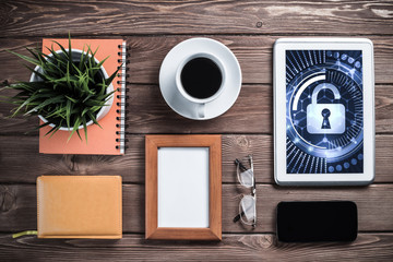 Web security and technology concept with tablet pc on wooden table