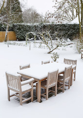 Snow covered garden and patio furniture