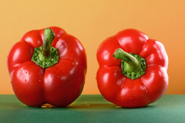 tomato and sweet pepper, paprika on the green table yellow background