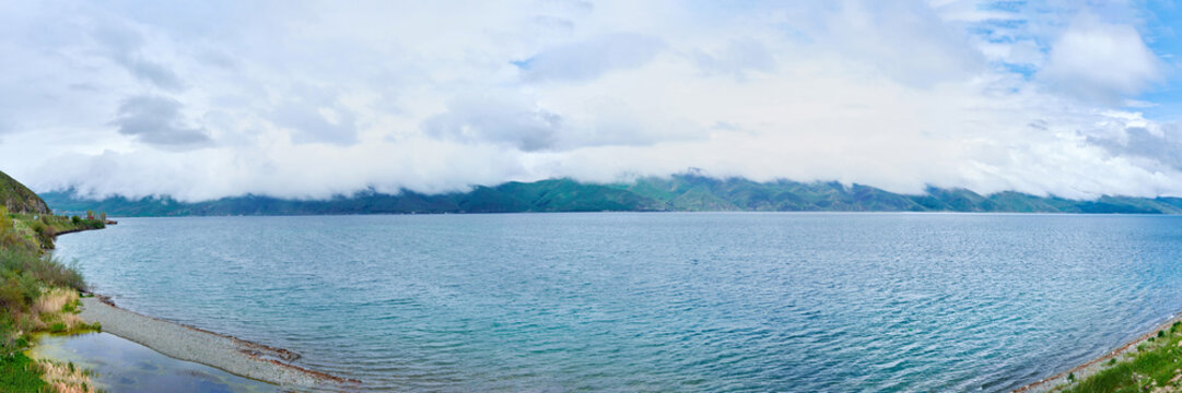 the endless water expanses of the lake Sevan on a cloudy day with clouds in the sky.