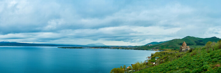 Fototapeta premium the endless water expanses of the lake Sevan on a cloudy day with clouds in the sky.