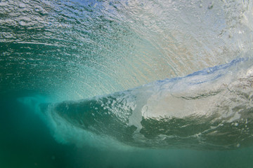 underwater view of a breaking wave on tropical island