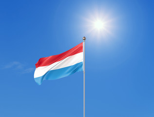 3D illustration. Colored waving flag of Luxembourg on sunny blue sky background.