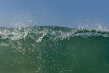 close up of a crashing wave breaking at you