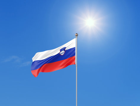 3D illustration. Colored waving flag of Slovenia on sunny blue sky background.