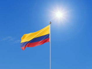 3D illustration. Colored waving flag of Colombia on sunny blue sky background.