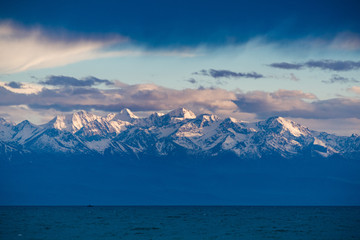 Snow-covered mountains and Lake Issyk Kul