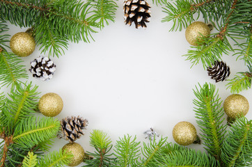 Fototapeta na wymiar New year frame mockup. Pine cones, fir branches and Christmas balls on white background. Flat lay, top view with copy space