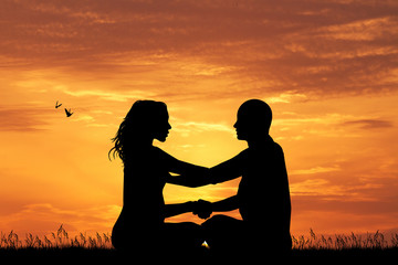 couple doing yoga at sunset