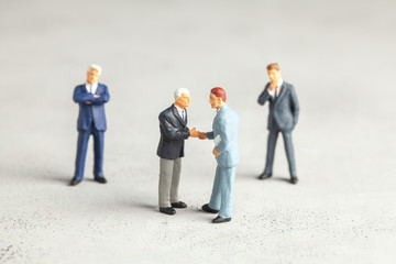Businessmen in suits shake hands. Contract or successful deal concept.