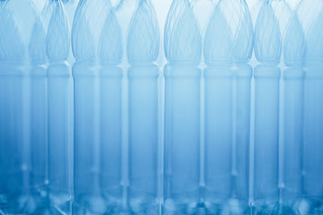 empty plastic bottles blue abstract background, close-up view