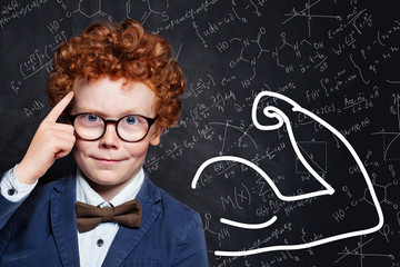 Clever little boy with red ginger hair on science background. Learn science concept