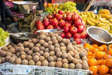 Indian street fresh fruits stall with variety of fruits along the road - image
