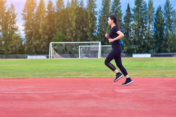 Obraz premium Runner Women jogging or running in evening at sunlight,Lady run jogging or exercise,Woman Runner or Girl Running