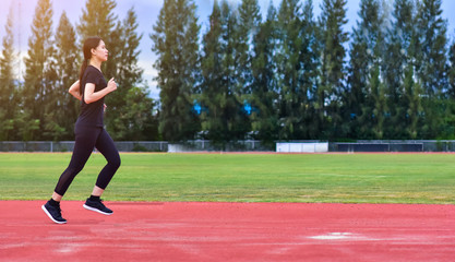 Obraz premium Runner Women jogging or running in evening at sunlight,Lady run jogging or exercise,Woman Runner or Girl Running