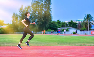 Obraz premium Runner Women jogging or running in evening at sunlight,Lady run jogging or exercise,Woman Runner or Girl Running