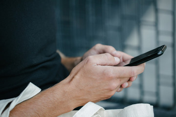 Man holding a phone over dark background