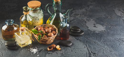 Obraz na płótnie Canvas Natural macadamia oil in a glass bottle with macadamia nuts