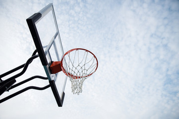 Basketball hoop with blue sky and cloud in park