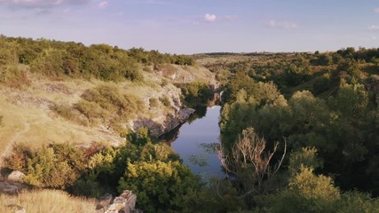Aerial shot of canyon with river during sunny day