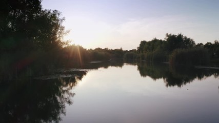 Aerial shot with drone flying close to the water in canyon during sunny day