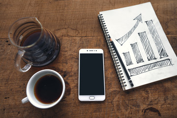Business Growth Draw graph in book In the morning,smartphone and coffee