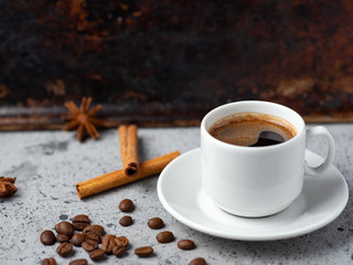 White espresso coffee Cup with cinnamon on rusty brown vintage background