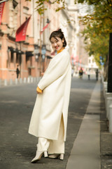 Fototapeta premium Asian girl in white coat