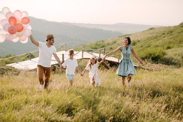 Happy family in nature. Happy family: mother, father, children son and daughter. life is made of little things.