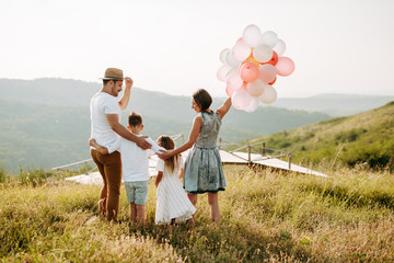 Happy family in nature. Happy family: mother, father, children son and daughter. life is made of little things.