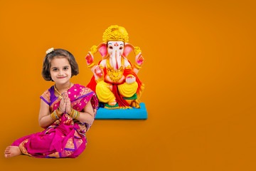 Little indian girl with lord ganesha, Indian ganesh festival