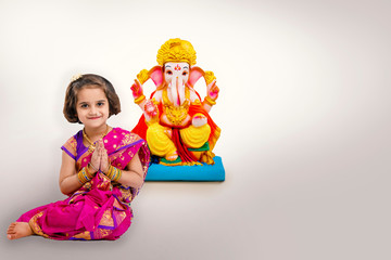Little indian girl with lord ganesha, Indian ganesh festival