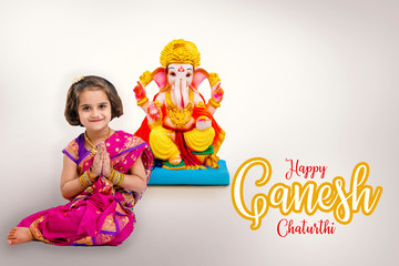 Little indian girl with lord ganesha, Indian ganesh festival