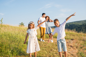 Happy family in nature. Happy family: mother, father, children son and daughter. life is made of little things.