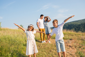 Happy family in nature. Happy family: mother, father, children son and daughter. life is made of little things.
