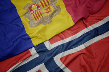 waving colorful flag of norway and national flag of andorra.