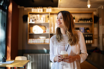 Happy beautiful young woman resting in coffee shop