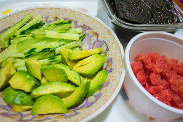 Sliced avocado, salted pollack roe, julienned cucumber and dried seaweed. Healthy food. 