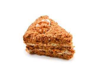 Peace of honey cake isolated on white background.