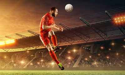 Soccer player in action on a field with the ball. Sports game. Soccer  championship. Floodlit...