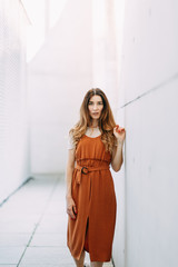 light portraits of a young girl on a white background. stylish image in the modern architecture of the building.