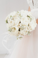 white bride's bouquet in the hands of the bride