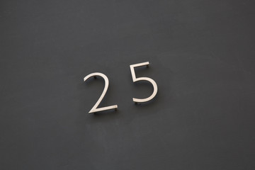 Number Twenty-Five on Black Wall
