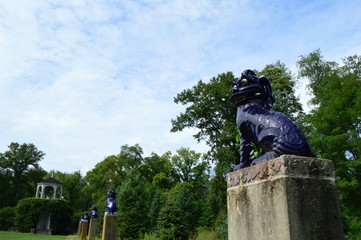 statue in the park with sky and trees