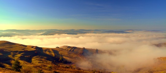 landscape with fog between hills seen from above