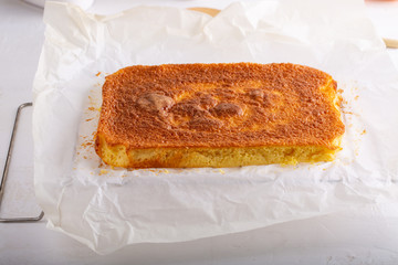 Homemade citrus sponge cake. Orange biscuit on white table.