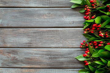green herbs and red berries for summer design on wooden background top view mock up